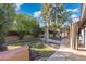 Stone pathway meanders through a lush green backyard at 8340 E Thomas Rd, Scottsdale, AZ 85251