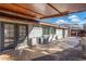Covered patio with flagstone flooring and access to the backyard at 8340 E Thomas Rd, Scottsdale, AZ 85251