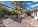 Landscaped backyard with a large patio, pergola, and grassy area at 8340 E Thomas Rd, Scottsdale, AZ 85251