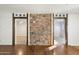 Hallway with stone accent wall and access to rooms at 8340 E Thomas Rd, Scottsdale, AZ 85251