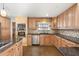 Updated kitchen with granite counters and wood cabinets at 8340 E Thomas Rd, Scottsdale, AZ 85251