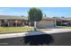 Front view of single-story home with mature tree at 10137 W Mountain View Rd, Sun City, AZ 85351