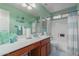 Clean bathroom with light green walls and bathtub at 10610 E Carol Ave, Mesa, AZ 85208