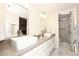 Bathroom with double sinks, large vanity, and a separate shower at 11059 E Yucca St, Scottsdale, AZ 85259