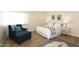 Bedroom with a queen-size bed, a comfortable armchair, and a rug at 11059 E Yucca St, Scottsdale, AZ 85259