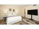 Main bedroom with a queen bed, large TV, and ensuite bathroom access at 11059 E Yucca St, Scottsdale, AZ 85259