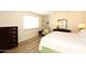 Bedroom with king-size bed, built-in shelving, and hardwood floors at 11059 E Yucca St, Scottsdale, AZ 85259