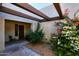 Inviting courtyard entry with wood pergola and colorful plants at 11059 E Yucca St, Scottsdale, AZ 85259