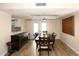 Dining room with large table and chairs, hardwood floors and access to kitchen at 11059 E Yucca St, Scottsdale, AZ 85259