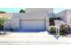Tan two-story home with a two-car garage and nicely landscaped yard at 11059 E Yucca St, Scottsdale, AZ 85259