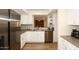 Modern kitchen with white cabinets, stainless steel appliances, and quartz countertops at 11059 E Yucca St, Scottsdale, AZ 85259