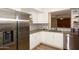 Modern kitchen with white cabinets, stainless steel appliances, and quartz countertops at 11059 E Yucca St, Scottsdale, AZ 85259