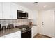 Modern kitchen with white cabinets, stainless steel appliances, and a gas stove at 11059 E Yucca St, Scottsdale, AZ 85259