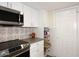 Modern kitchen with white cabinets, stainless steel appliances, and a built-in microwave at 11059 E Yucca St, Scottsdale, AZ 85259