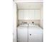 Laundry room with washer, dryer, and overhead cabinets at 11059 E Yucca St, Scottsdale, AZ 85259