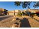 Tan two-story house with three car garage, desert landscaping, and mountain views at 11138 E Verbena Ln, Scottsdale, AZ 85255