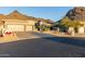 Tan two-story house with three car garage, desert landscaping, and mountain views at 11138 E Verbena Ln, Scottsdale, AZ 85255