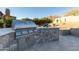 High-end outdoor kitchen with built-in grill and stone countertops at 11138 E Verbena Ln, Scottsdale, AZ 85255