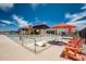 Resort-style pool with a splash pad, lounge chairs, and umbrellas at 13240 E Larrea Ln, Florence, AZ 85132