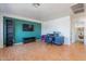 Home office with wood floors, a built-in shelving unit and an accent wall at 13309 N 124Th Ave, El Mirage, AZ 85335