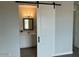 Bathroom with barn door entry and modern vanity at 13634 S 192Nd Ave, Buckeye, AZ 85326