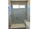 Walk-in shower with marble-look tile and built-in bench at 13634 S 192Nd Ave, Buckeye, AZ 85326