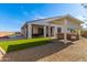 Covered patio with outdoor kitchen, lush green grass and a sparkling pool at 13930 W Tierra Grande --, Surprise, AZ 85387