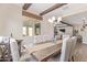 Bright dining room with a rustic table and view into the living room at 13930 W Tierra Grande --, Surprise, AZ 85387