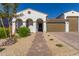 Stunning curb appeal! This home features a charming exterior, a brick walkway and landscaping at 13930 W Tierra Grande --, Surprise, AZ 85387
