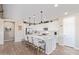 Modern kitchen with white cabinets, stainless steel appliances, and an island with seating at 13930 W Tierra Grande --, Surprise, AZ 85387