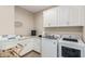 Well-equipped laundry room with washer, dryer, and cabinets at 13930 W Tierra Grande --, Surprise, AZ 85387
