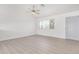 Bright living room with light wood floors and ceiling fan at 142 N 86Th Pl, Mesa, AZ 85207