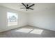 Well-lit bedroom, featuring a ceiling fan and carpeted floor at 1436 E Downing St, Mesa, AZ 85203