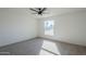 Bright bedroom with ceiling fan and large window, carpeted floor at 1436 E Downing St, Mesa, AZ 85203