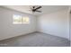Comfortable bedroom with ceiling fan and neutral carpet at 1436 E Downing St, Mesa, AZ 85203