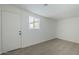 Bright bedroom with neutral carpet, door, and window at 1436 E Downing St, Mesa, AZ 85203