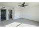 Spacious bedroom with ceiling fan, carpet, and access to bathroom at 1436 E Downing St, Mesa, AZ 85203