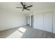 Bright bedroom with ceiling fan and carpet flooring, access to hallway at 1436 E Downing St, Mesa, AZ 85203
