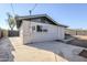 Rear exterior of the house showing a concrete patio and access to the backyard at 1436 E Downing St, Mesa, AZ 85203