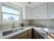 Kitchen with white cabinets, quartz countertops and stainless steel sink at 1436 E Downing St, Mesa, AZ 85203
