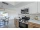 Modern kitchen with stainless steel appliances and white and wood cabinets at 1436 E Downing St, Mesa, AZ 85203