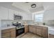 Modern kitchen featuring white and wood cabinets, quartz countertops and stainless steel appliances at 1436 E Downing St, Mesa, AZ 85203