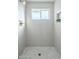 Clean and updated shower with white tile and herringbone floor at 1436 E Downing St, Mesa, AZ 85203