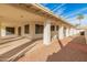 Covered patio with gravel yard and access to side yard at 14543 W Bison Path, Surprise, AZ 85374