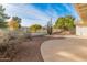 Landscaped backyard with gravel, cacti, and a curved patio at 14543 W Bison Path, Surprise, AZ 85374