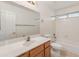 Bathroom with tub, single vanity, and wood cabinet at 14543 W Bison Path, Surprise, AZ 85374