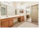 Double vanity bathroom with wood cabinets at 14543 W Bison Path, Surprise, AZ 85374