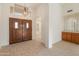 Bright entryway with double doors, tile flooring, and built-in shelving at 14543 W Bison Path, Surprise, AZ 85374