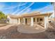 House exterior showcasing a covered patio and desert landscaping at 14543 W Bison Path, Surprise, AZ 85374