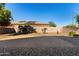 Large backyard with gravel, trees, and a block wall at 16468 W Mariposa Grande --, Surprise, AZ 85387